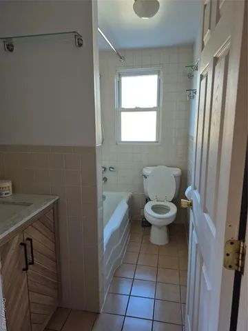 a bathroom with a toilet a sink and a window