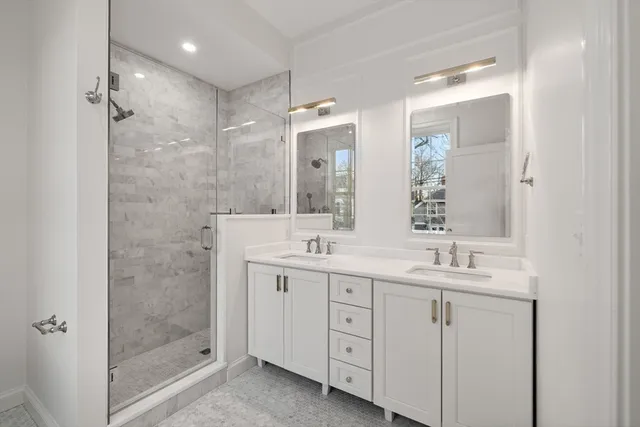 a bathroom with a granite countertop sink a toilet and shower