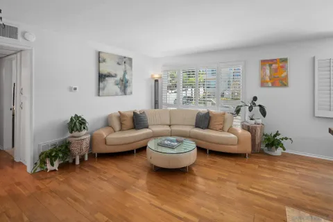 a living room with furniture and a wooden floor