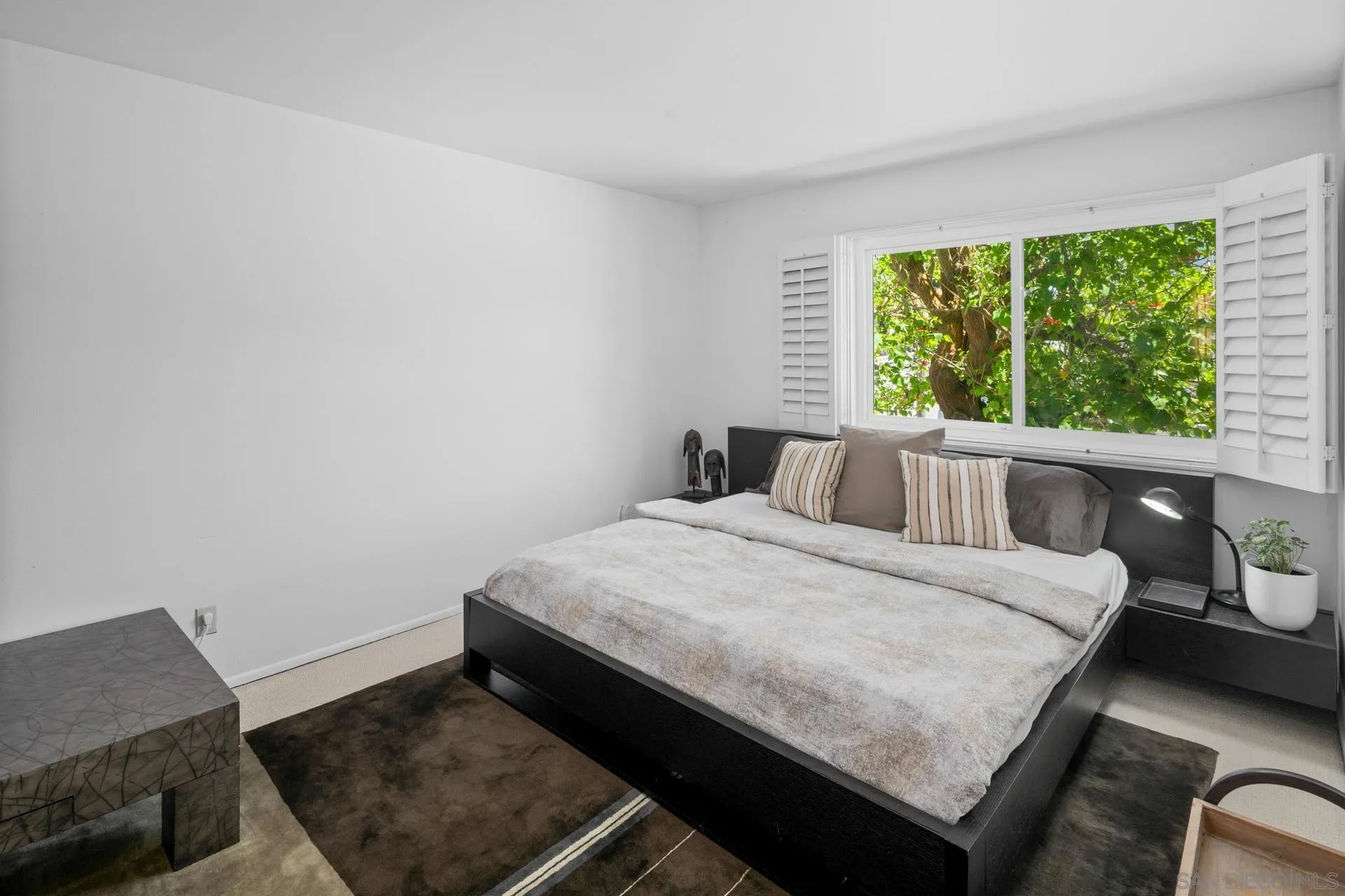 3266 1st Avenue, Unit 20 San Diego, CA 92103 - Photo 14 of 37 a bed sitting in a bedroom next to a window