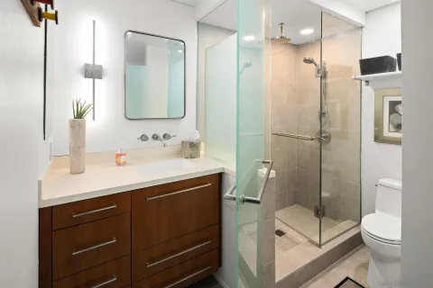 a bathroom with a sink toilet and shower