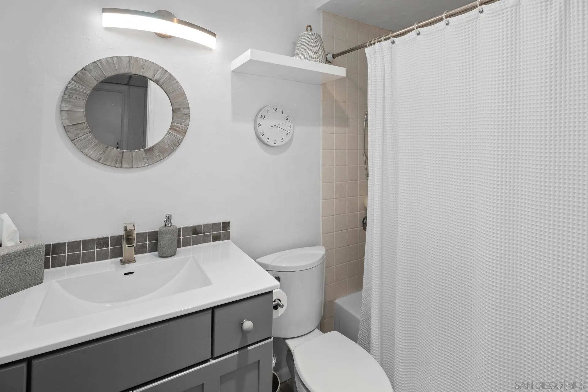 3266 1st Avenue, Unit 20 San Diego, CA 92103 - Photo 20 of 37 a bathroom with a toilet a sink and mirror