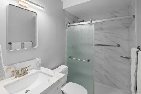 a bathroom with a sink toilet and shower