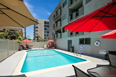 a view of a patio with a table and chairs under an umbrella