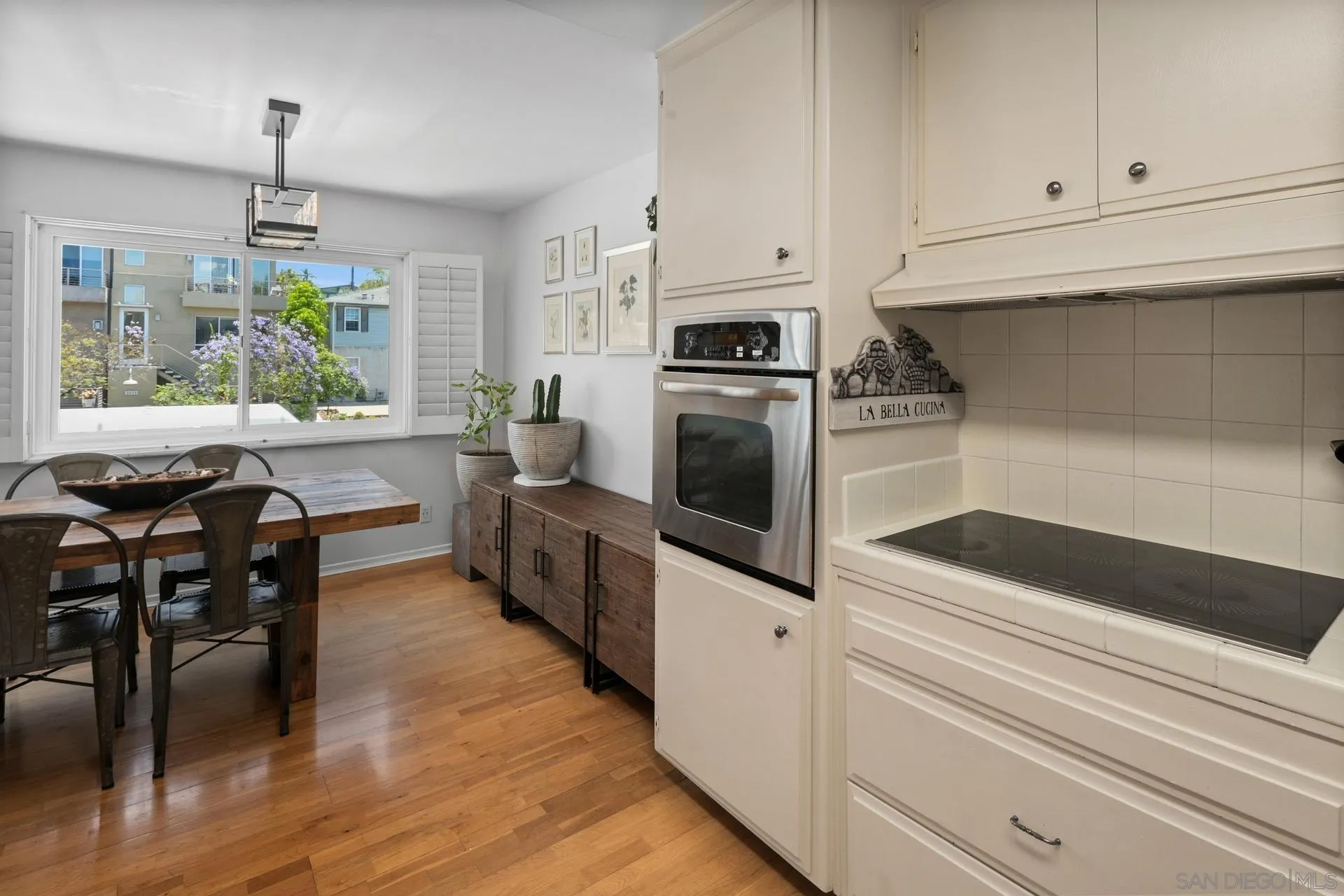 3266 1st Avenue, Unit 20 San Diego, CA 92103 - Photo 9 of 37 a kitchen with granite countertop a stove a sink and chairs