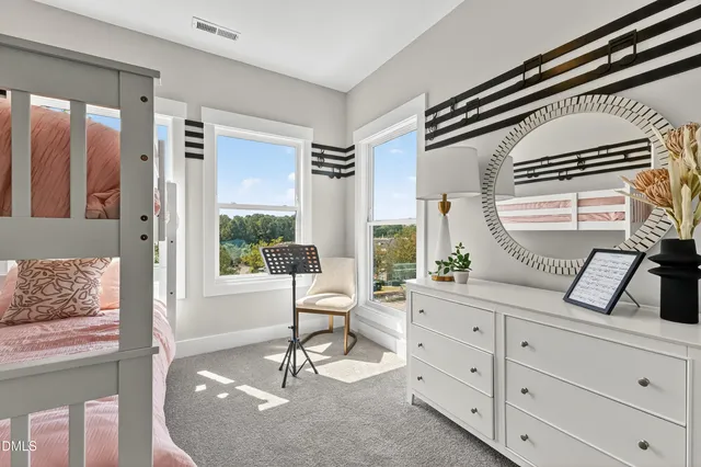 a living room with furniture and large windows