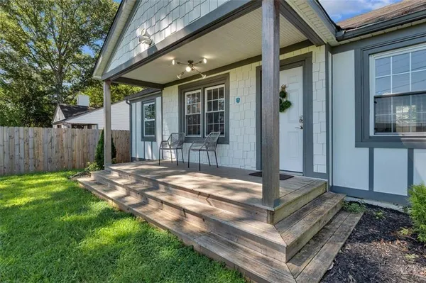 a view of a house with backyard and sitting area
