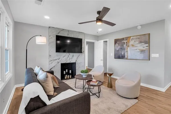 a living room with furniture a fireplace and a flat screen tv