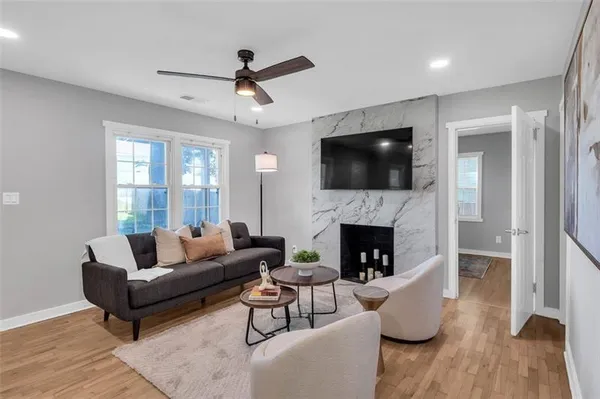 a living room with furniture a fireplace and a flat screen tv