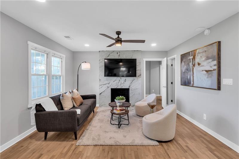 3910 Clairmont Road Atlanta, GA 30341 - Photo 6 of 23 a living room with furniture a fireplace and a flat screen tv