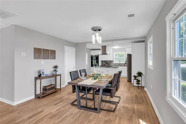 a view of a dining room with furniture and wooden floor