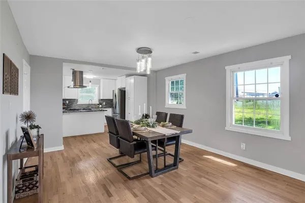 a view of a dining room with furniture and a window