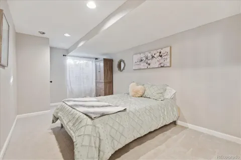 a bedroom with a bed and a painting on the wall