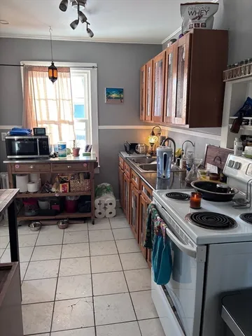 a kitchen with a stove a sink and a microwave