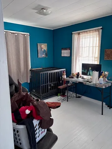 a bedroom with furniture and a window