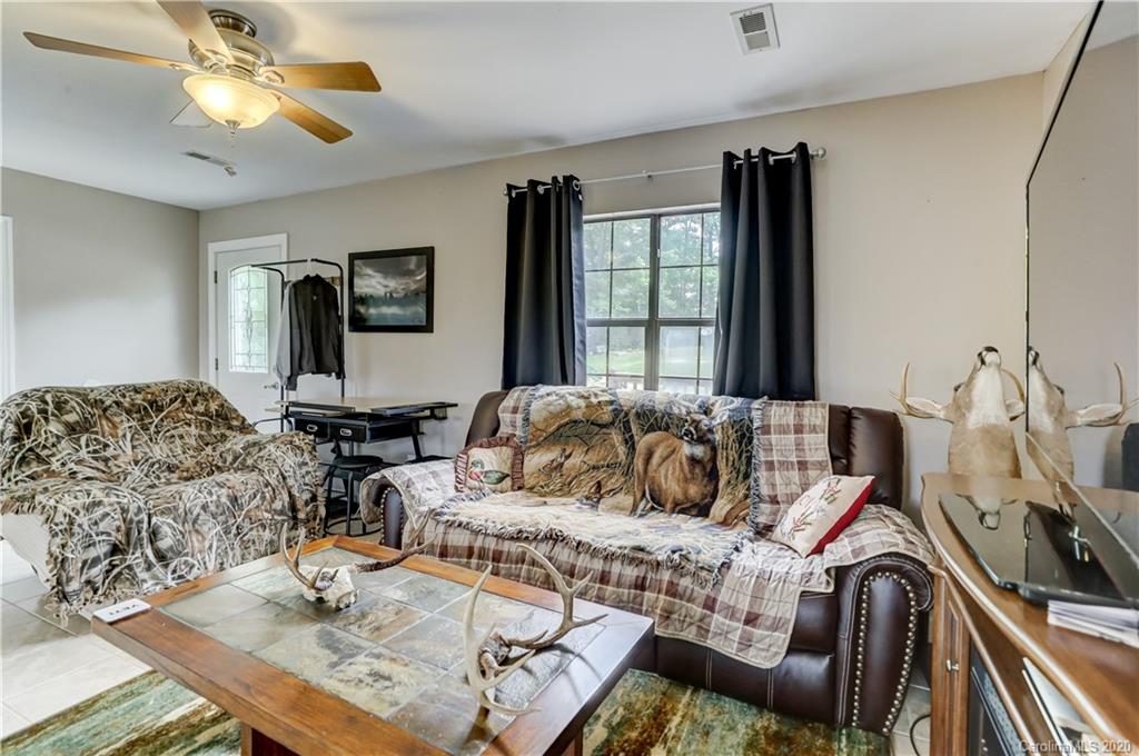 1024 Willis Farm Road Clover, SC 29710 - Photo 13 of 48 a living room with furniture a flat screen tv and a large window