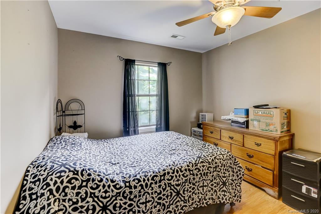 1024 Willis Farm Road Clover, SC 29710 - Photo 19 of 48 a bedroom with a bed and a chandelier