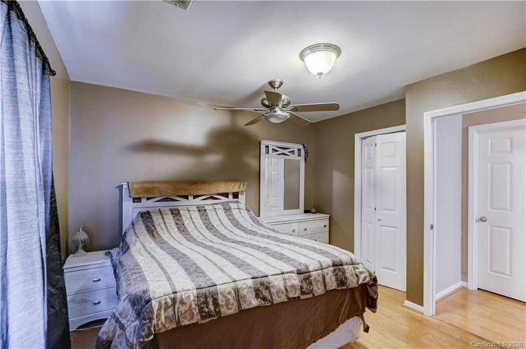 1024 Willis Farm Road Clover, SC 29710 - Photo 22 of 48 a bedroom with a bed and a chandelier