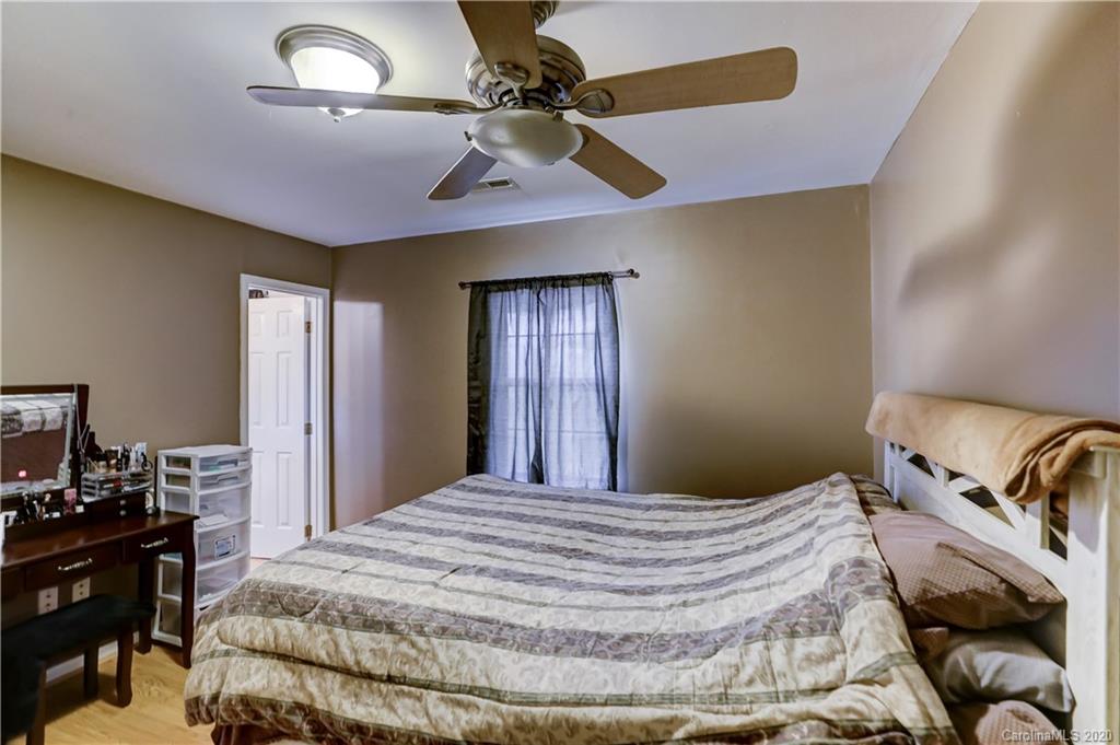 1024 Willis Farm Road Clover, SC 29710 - Photo 23 of 48 a bedroom with a bed and a chandelier