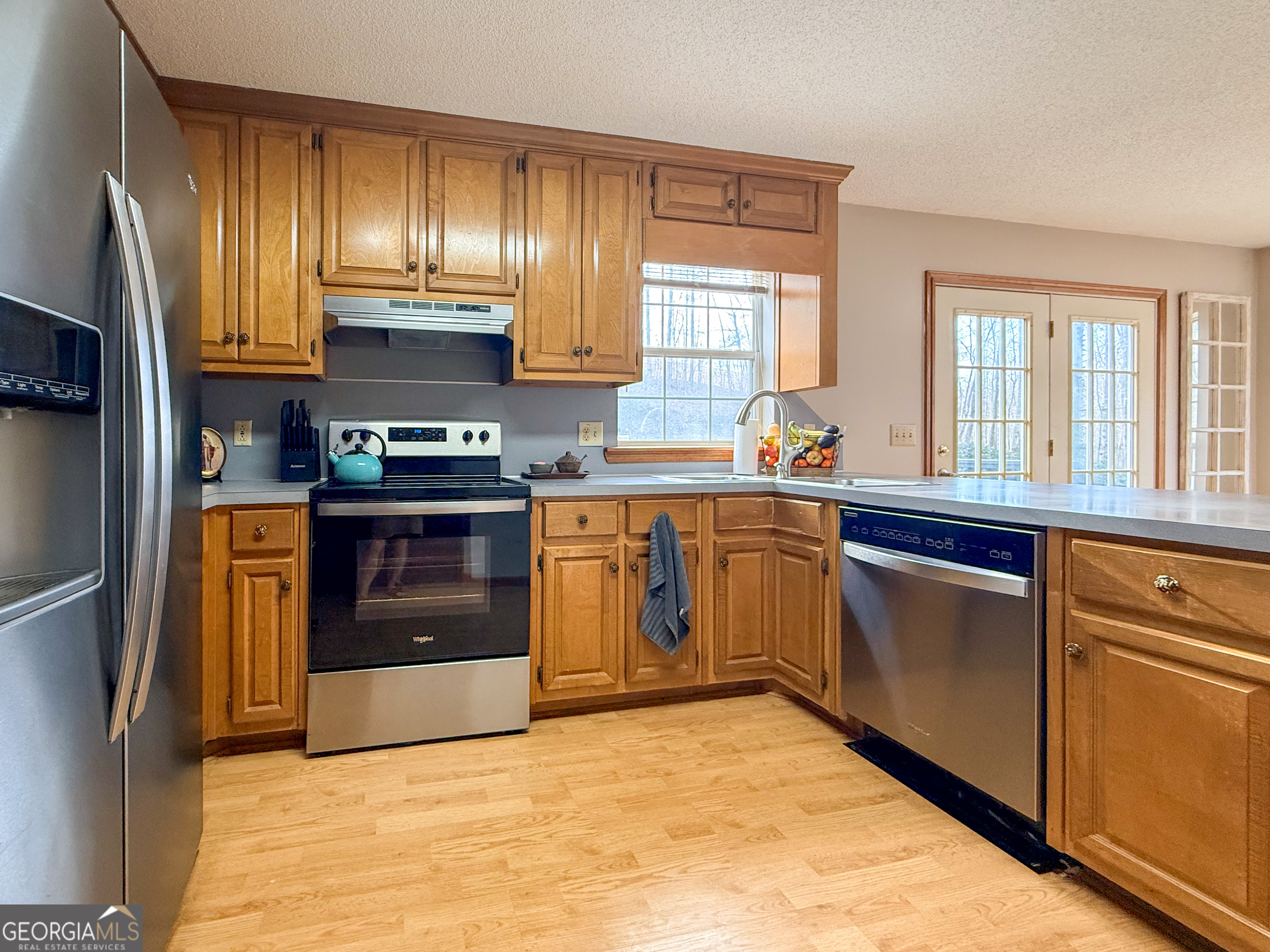 354 Prairie Flower Drive Cleveland, GA 30528 - Photo 14 of 49 a kitchen with stainless steel appliances granite countertop a stove a sink and a refrigerator