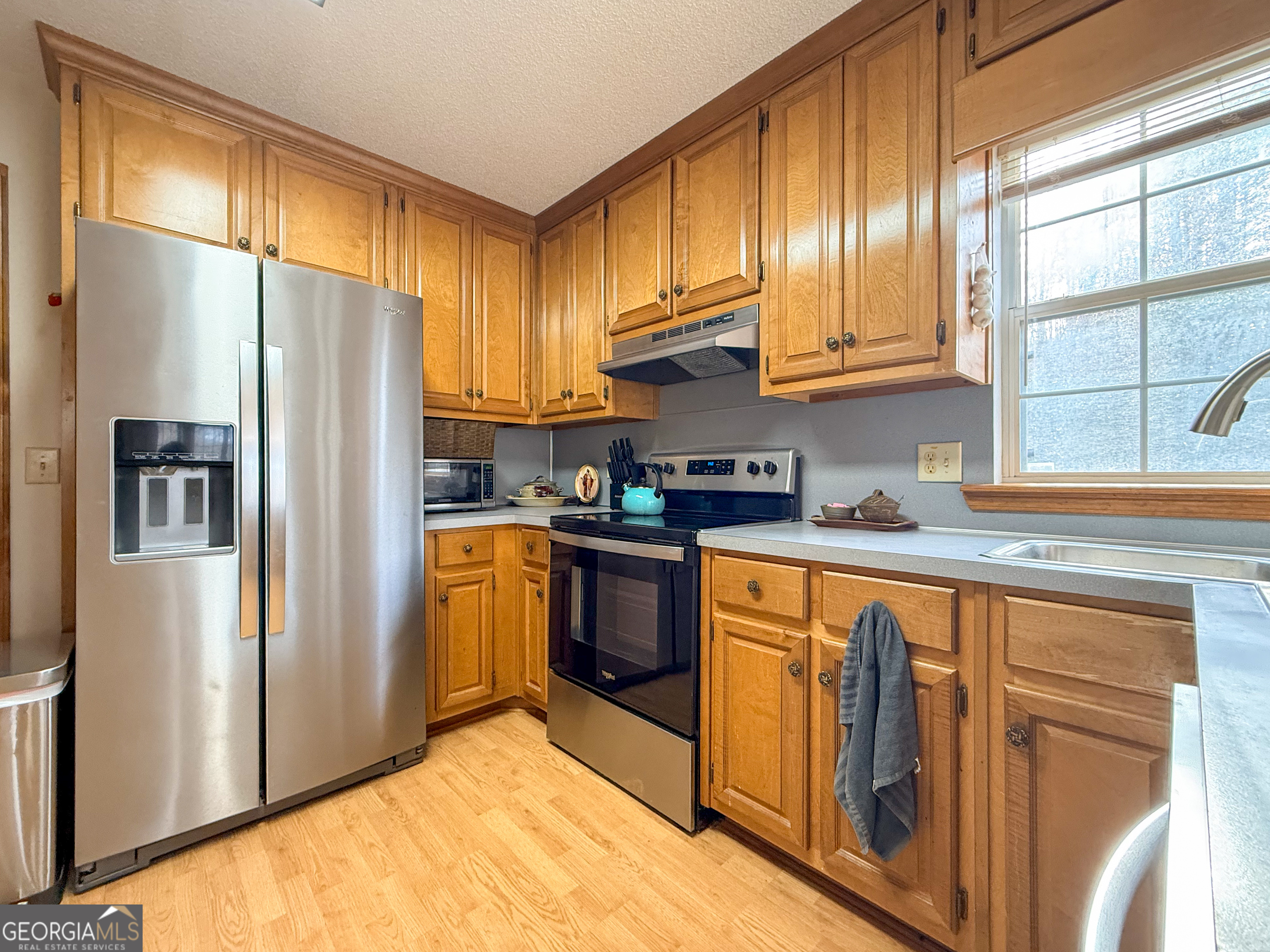 354 Prairie Flower Drive Cleveland, GA 30528 - Photo 15 of 49 a kitchen with stainless steel appliances granite countertop a refrigerator a sink dishwasher a stove and white countertops with cabinets