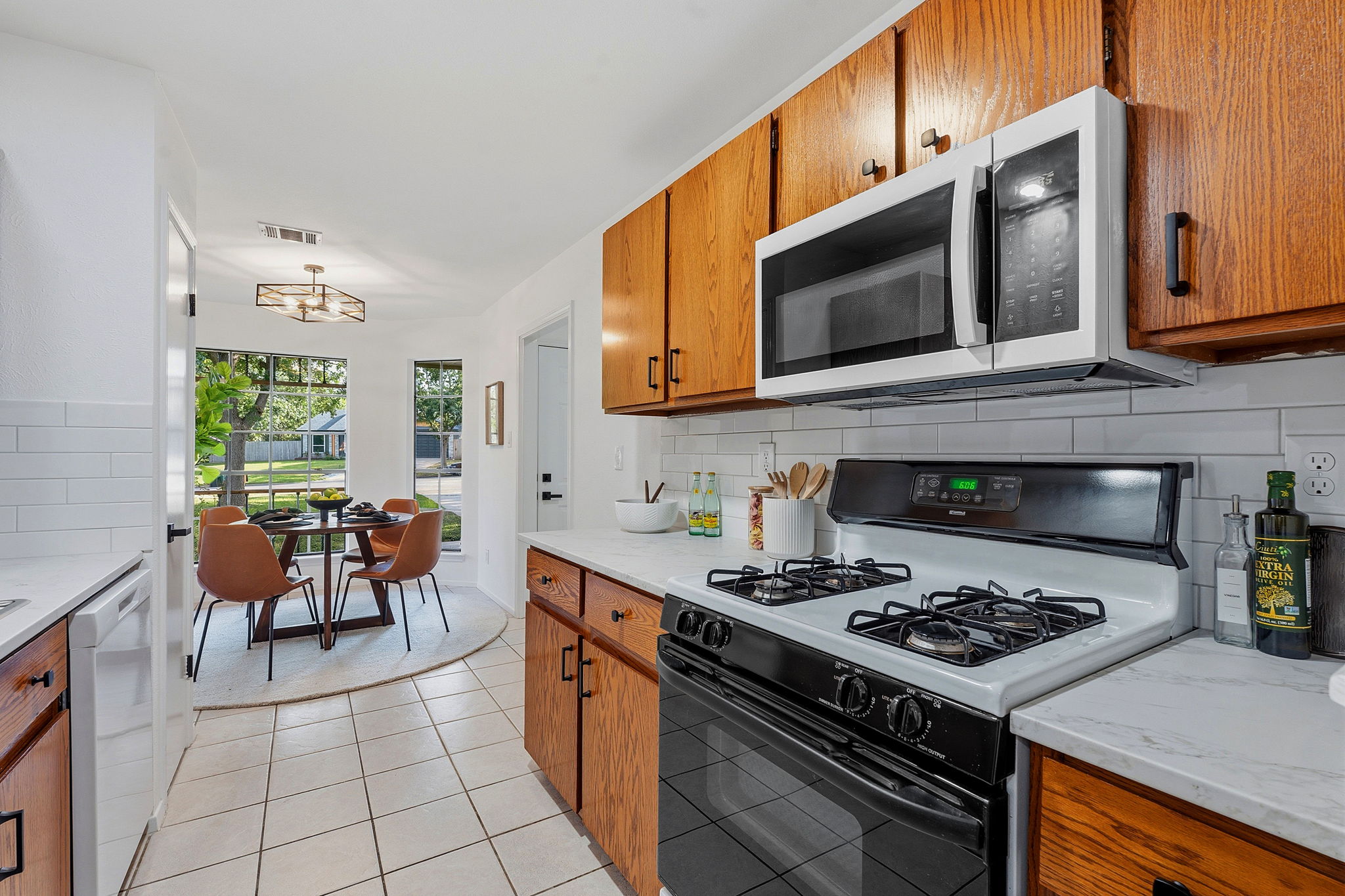 2702 Calabash Cove Austin, TX 78745 - Photo 18 of 40 a kitchen with stainless steel appliances a stove a sink cabinets and a dining table