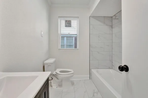 a bathroom with a sink a toilet and bathtub