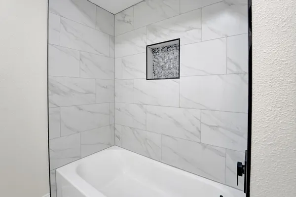 a bathroom with a white bath tub