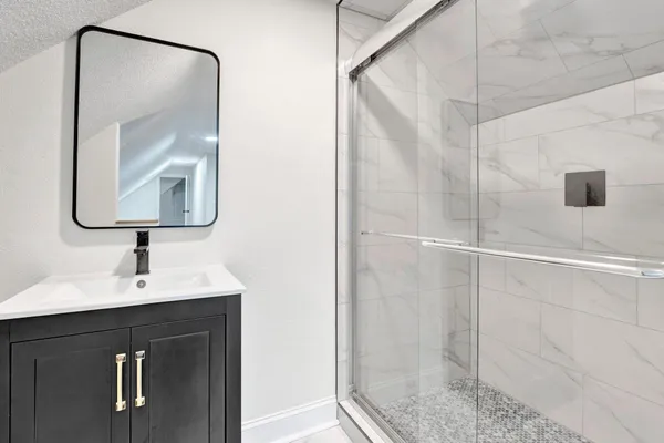 a bathroom with a mirror and a shower