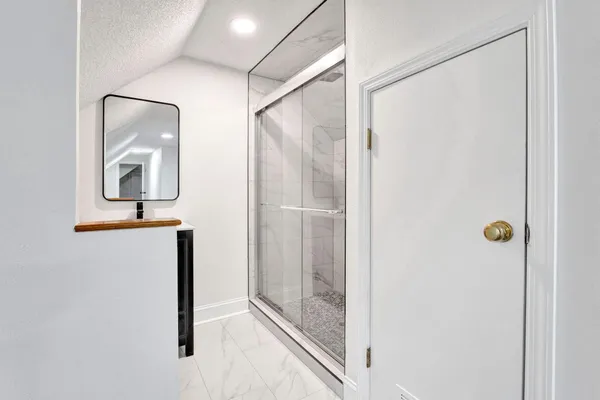 a view of a livingroom with furniture and an empty room