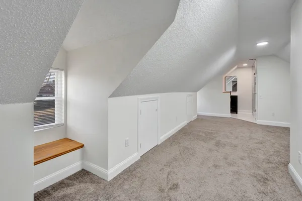 a view of an empty room with a kitchen