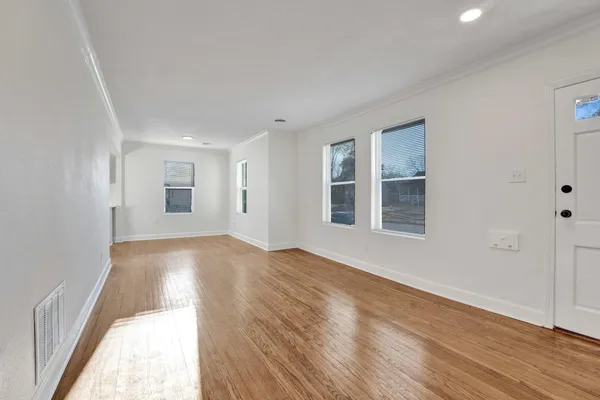 wooden floor in an empty room with a window