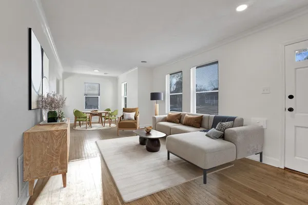 a living room with furniture and wooden floor
