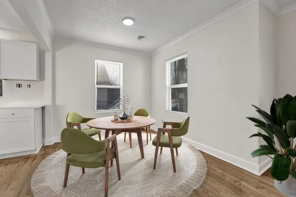 a view of a dining room with furniture and window