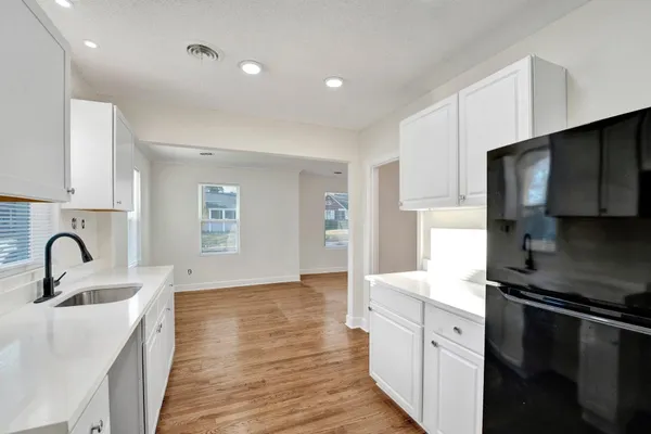 a kitchen with kitchen island stainless steel appliances a sink stove and refrigerator