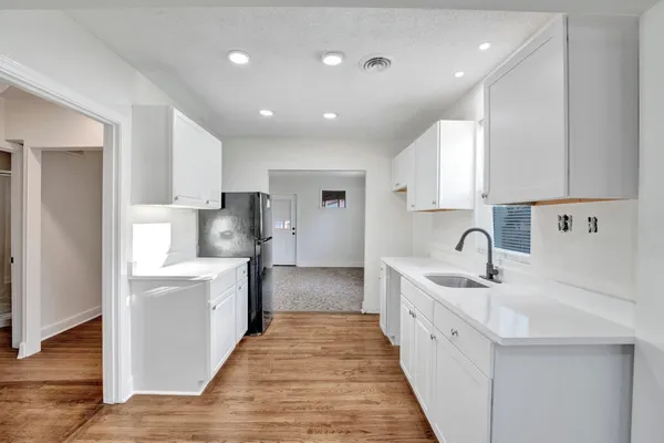 a large kitchen with kitchen island a sink stainless steel appliances and cabinets