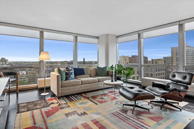 a living room with furniture city view and large windows