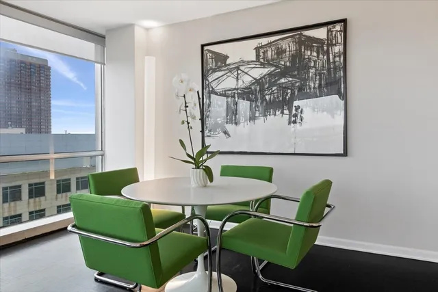 a living room with furniture and a painting on the wall