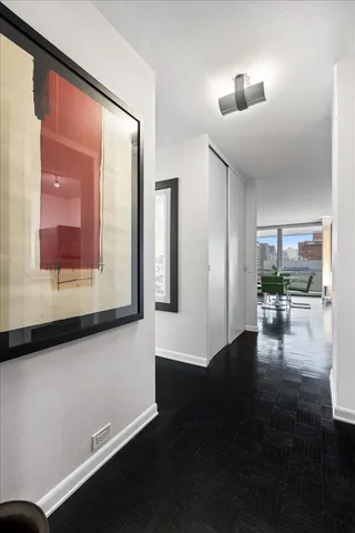 a hallway with dining room and wooden floor
