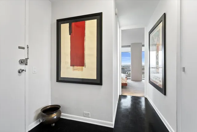 a hallway with a large window and front door