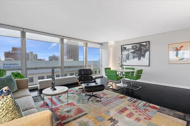 a living room with furniture and a floor to ceiling window