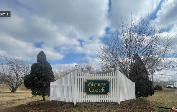 a view of a tree in front of a house