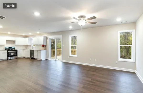 a view of a kitchen with a stove cabinets and a large window