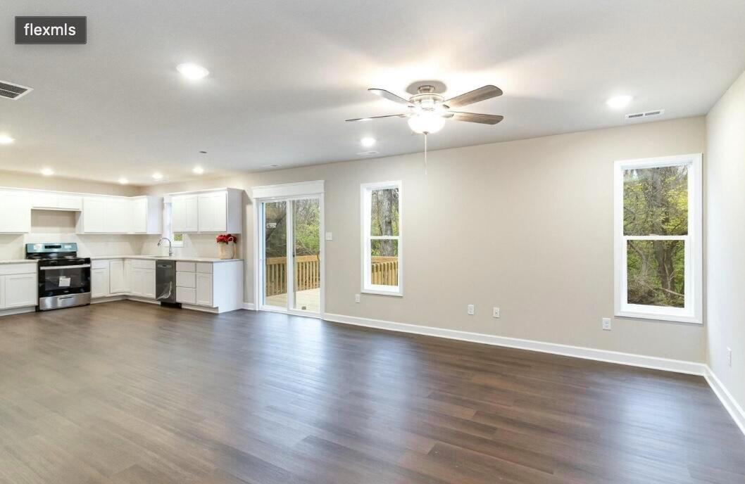416 Belvoir Road Kingsford Heights, IN 46346 - Photo 4 of 21 a view of an empty room with wooden floor and a window