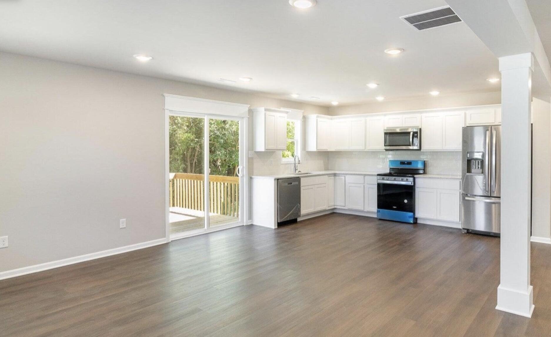 416 Belvoir Road Kingsford Heights, IN 46346 - Photo 5 of 21 a view of a kitchen with a stove cabinets and a large window