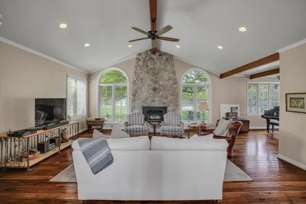 a living room with fireplace furniture and a flat screen tv