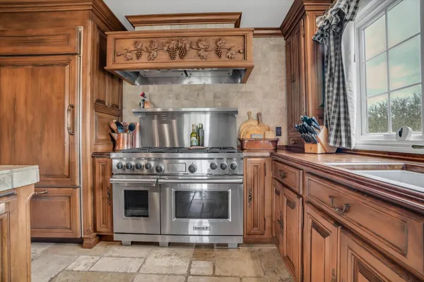 a kitchen with a stove and cabinets