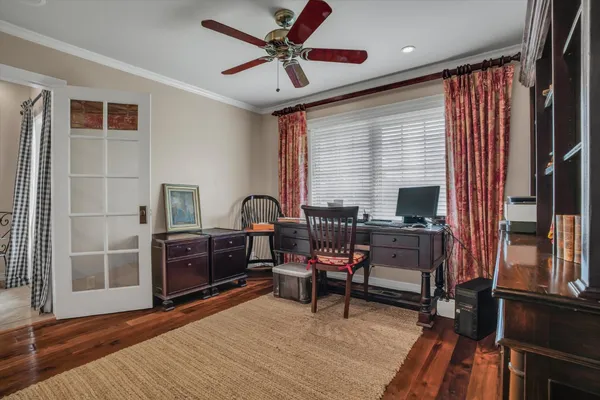 a view of a workspace with furniture and a window
