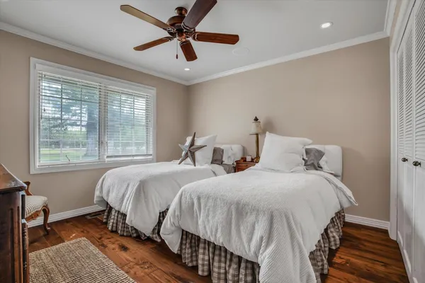 a bedroom with two beds and a chandelier