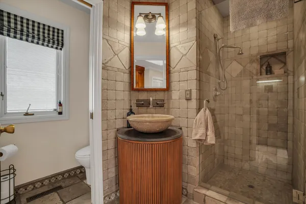 a bathroom with a sink toilet and shower